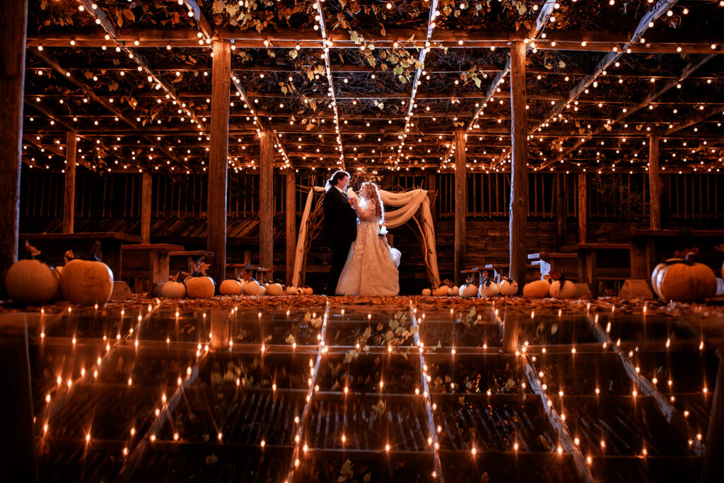 Artsy photo of bride and groom with twinkle lights surrounding them 