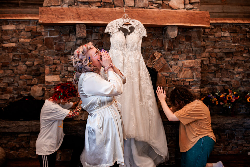 bridesmaids admiring brides wedding dress