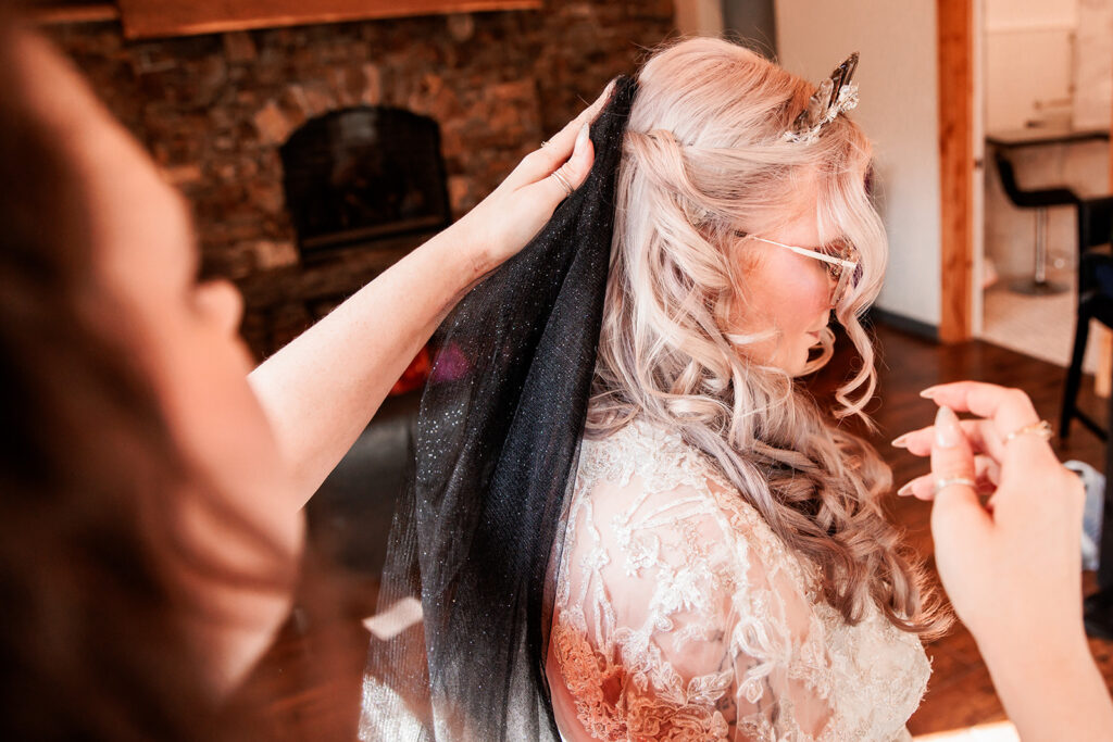 bride getting ready with sparkly black veil