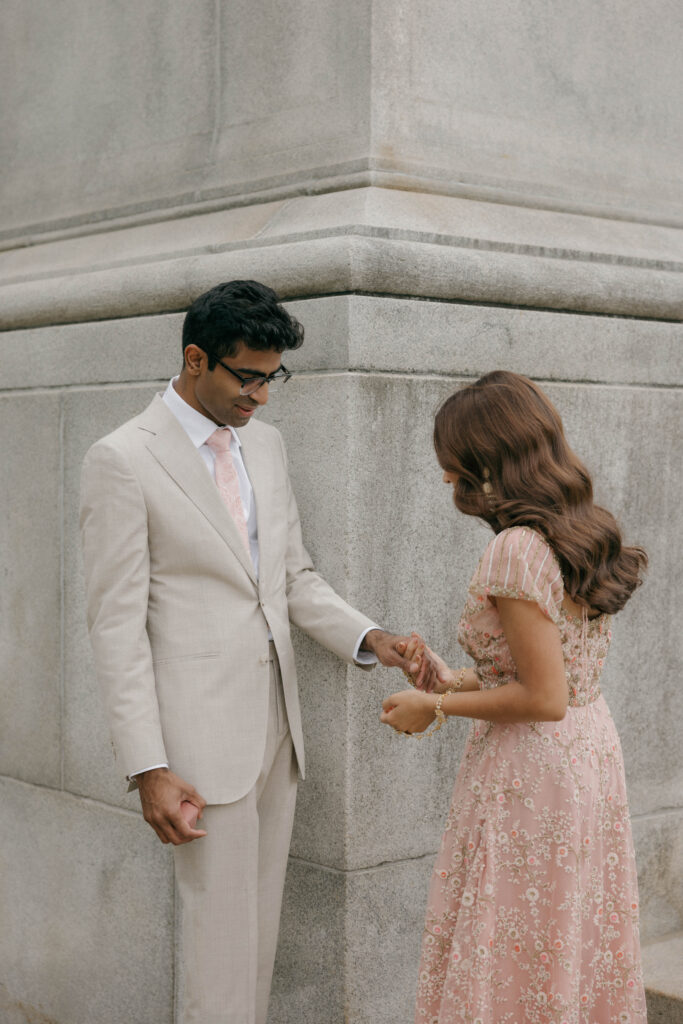 bride and groom admiring attire during first look