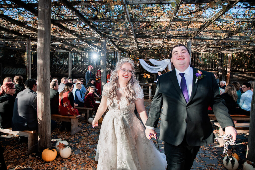 bride and groom recessional celebration at outdoor fall wedding