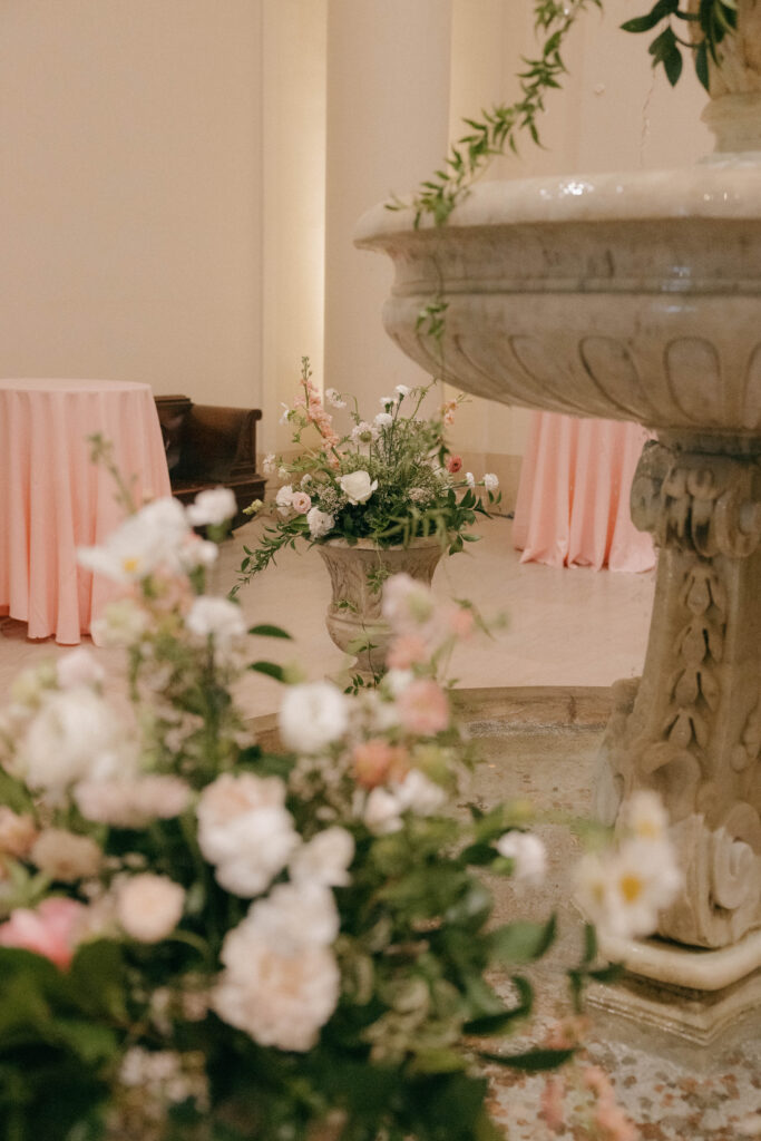 pink whimsical floral decor on water fountain