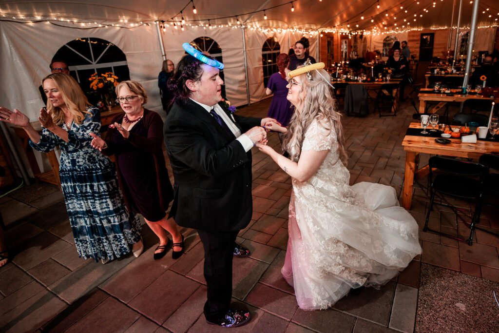 couple dancing at wedding with glowstick headbands