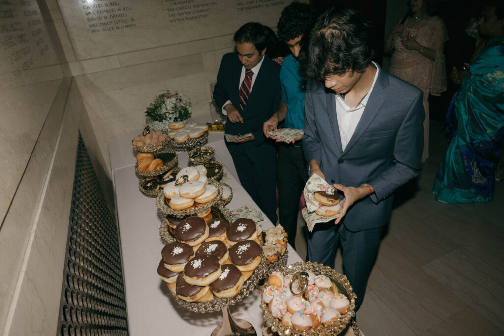 guests grabbing donuts from dessert display