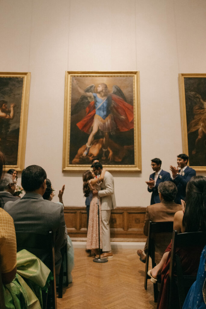 bride and groom kissing at non-traditional indian wedding ceremony in art museum