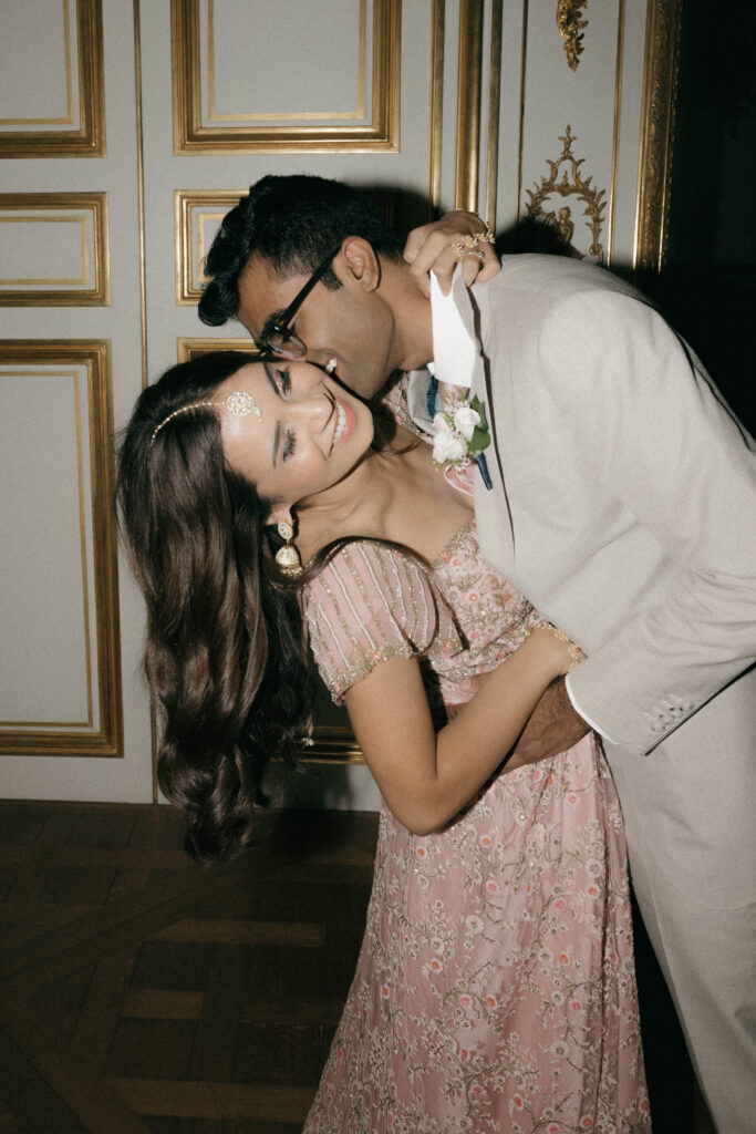 intimate groom kissing bride's cheek portrait with direct flash