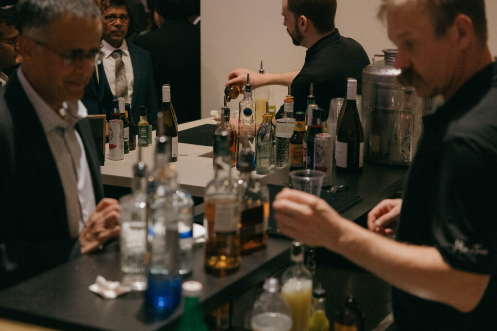 host a toast serving guests at wedding bar