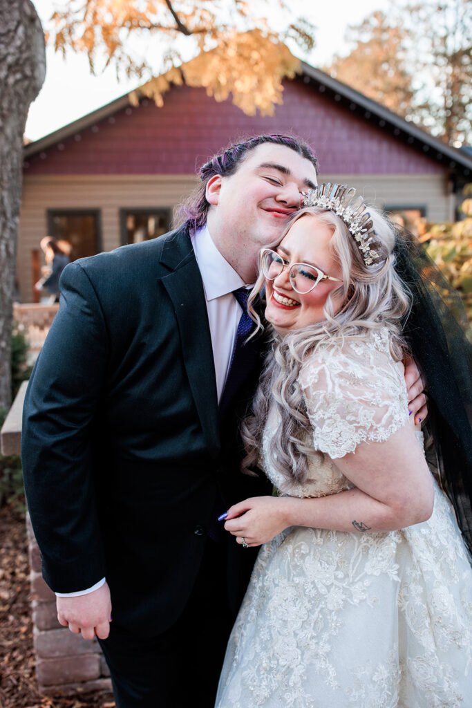 silly bride and groom portrait hugging and squishing faces