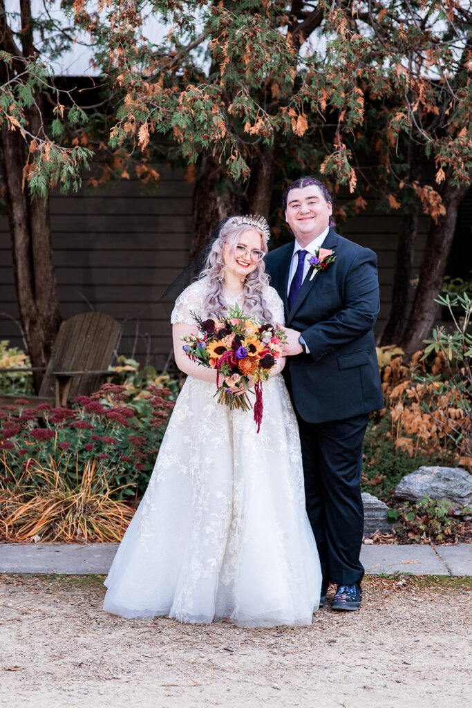 traditional bride and groom portrait with sunflower bouquet