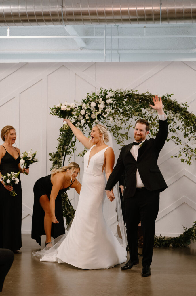 bride and groom cheering after ceremony at Mosaic wedding