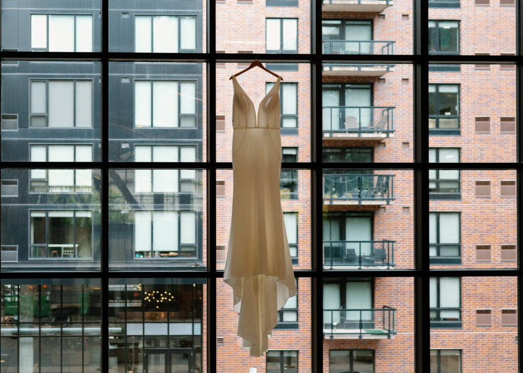 bridal gown hanging on window wall