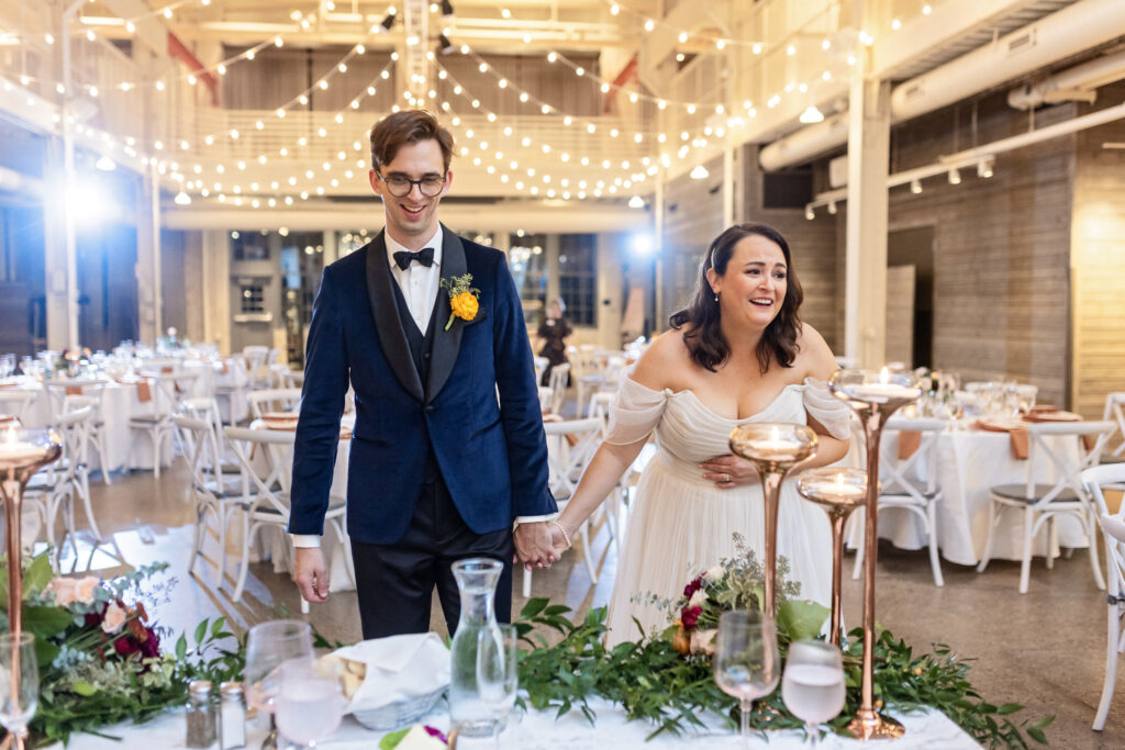 bride and groom reaction to wedding reception decor