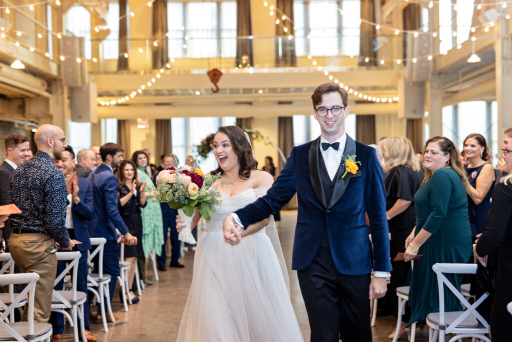 bride and groom celebrate recessional at Machine Shop wedding