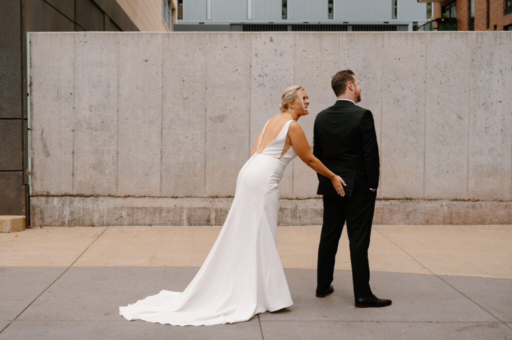 bride grabbing grooms butt for first look