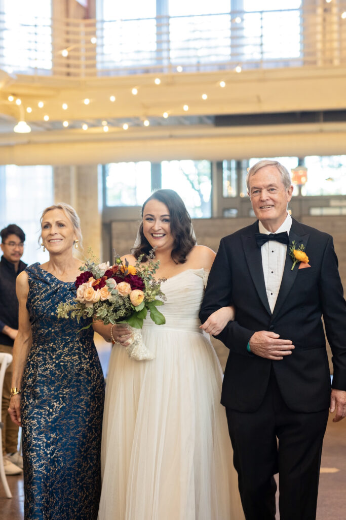 bride escorted down the aisle by both parents at Machine Shop wedding