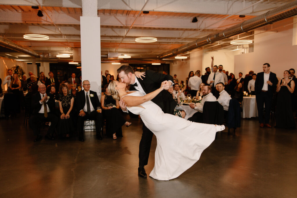 bride and groom first dance dip and kiss