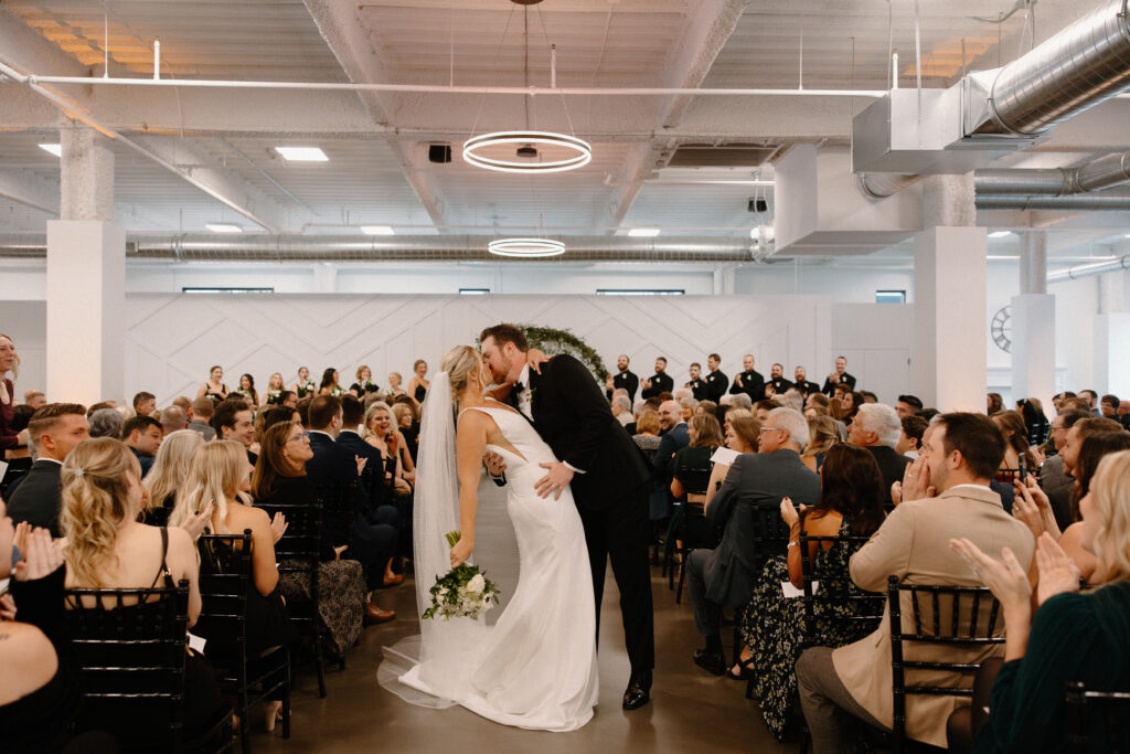 iconic bride and groom dip aisle kiss at Mosaic wedding