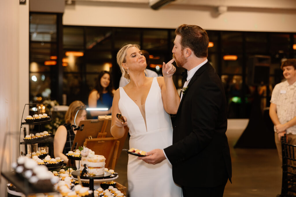 bride and groom cake cutting licking finger