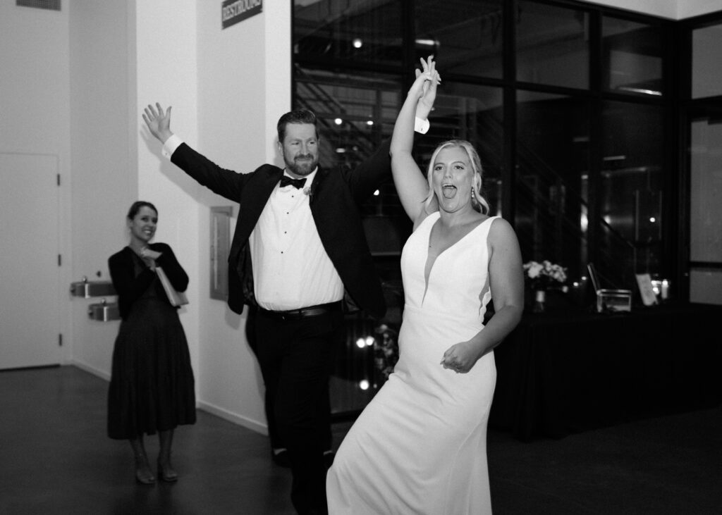 bride and groom cheering during grand entrance