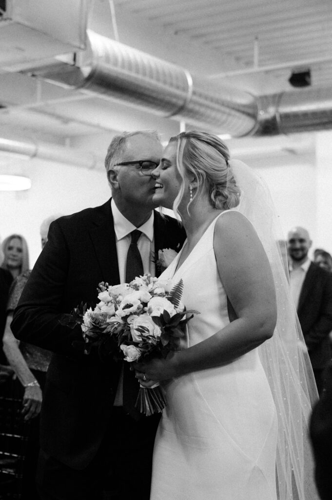 dad kissing bride's cheek at Mosaic wedding