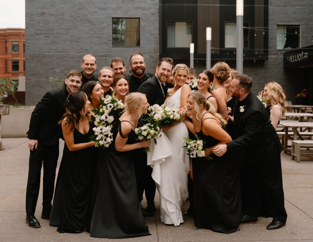 fun casual large wedding party portrait in black attire