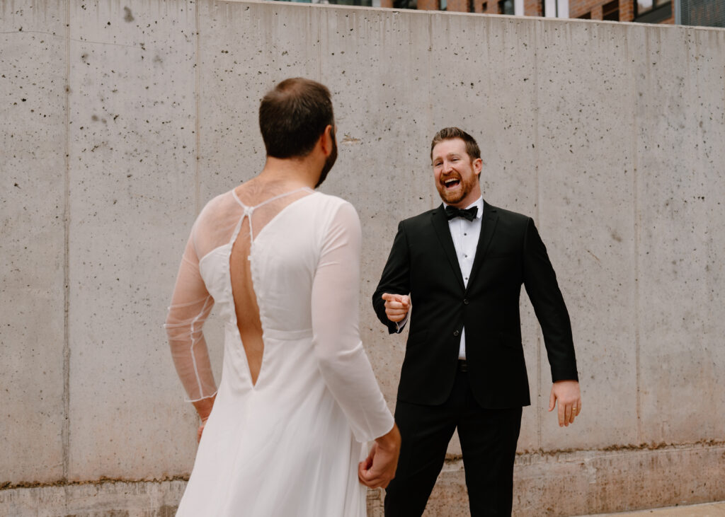 groom laughing at best man wearing wedding dress for first look prank