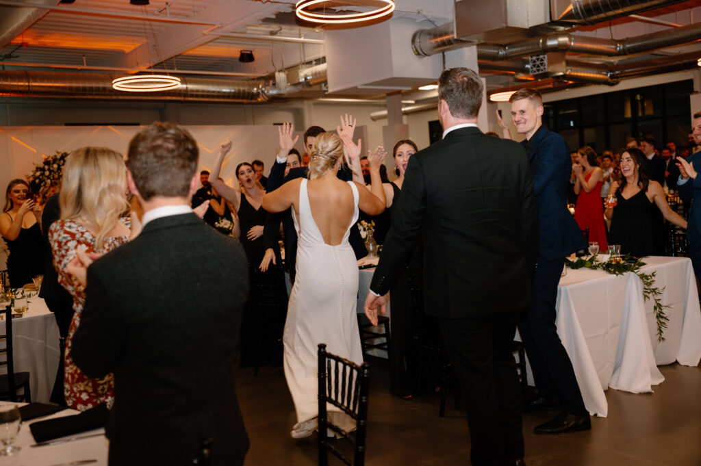 guests cheering for bride and groom during grand entrance