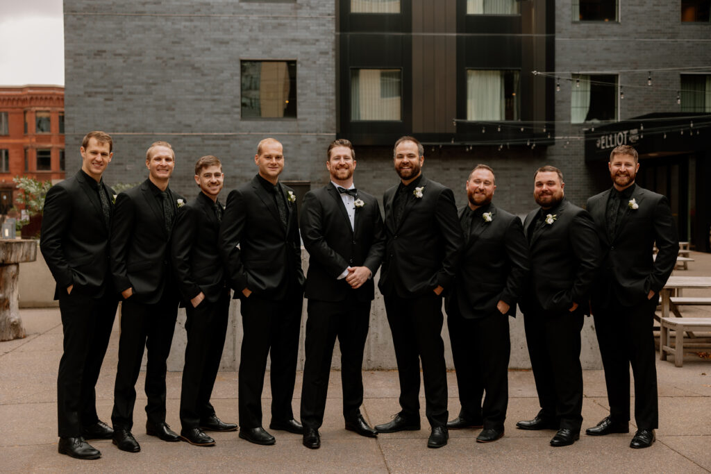 traditional groomsmen portrait in black suits