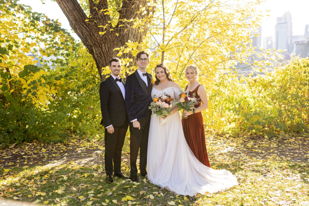 wedding party photo outside with fall leaves