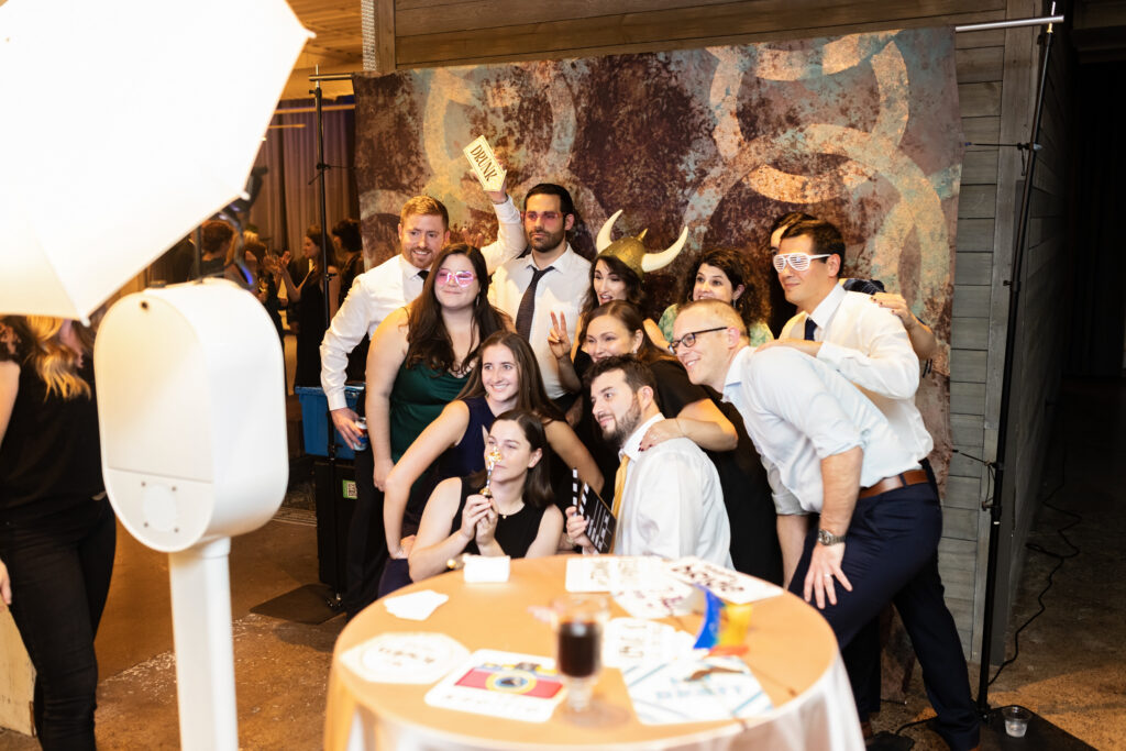 guests posing for group photo in Photo Booth at Machine Shop wedding