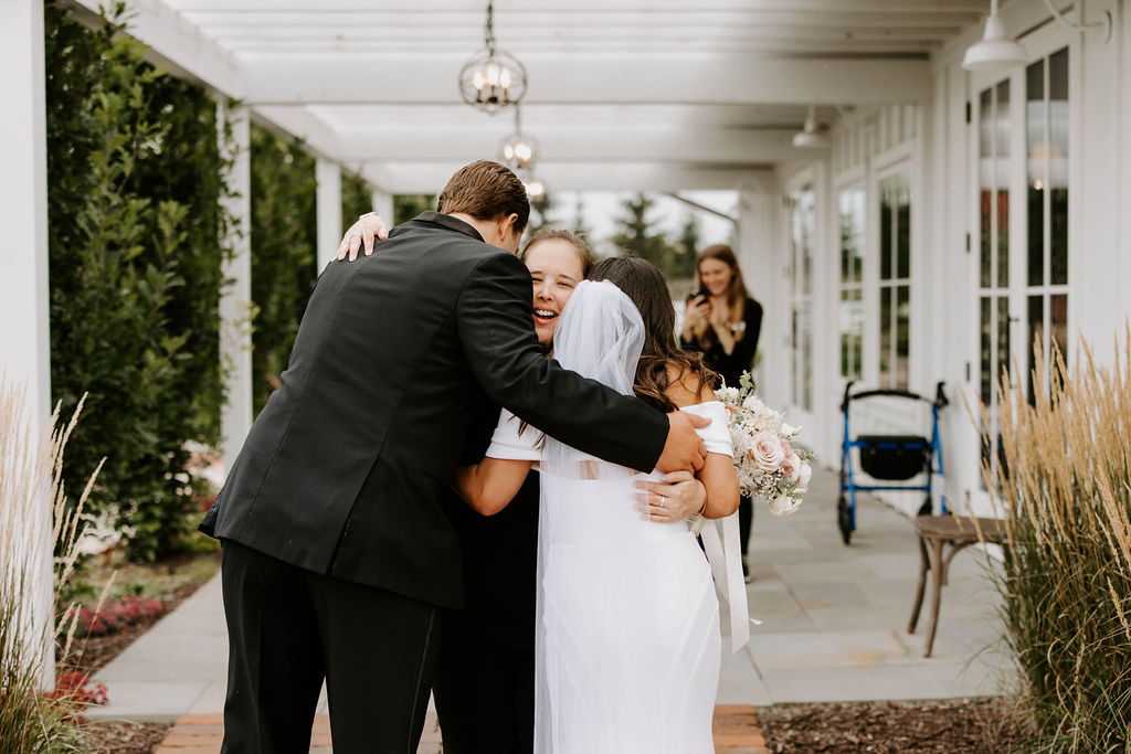 Couple hugging wedding coordinator