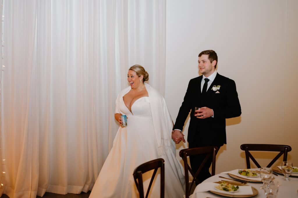 bride and groom reaction to reception at winter Urban Daisy wedding